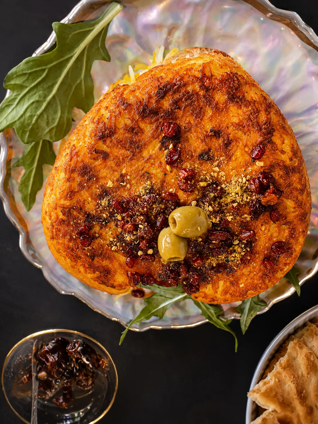 Golden chicken tahchin topped with barberries and pistachios