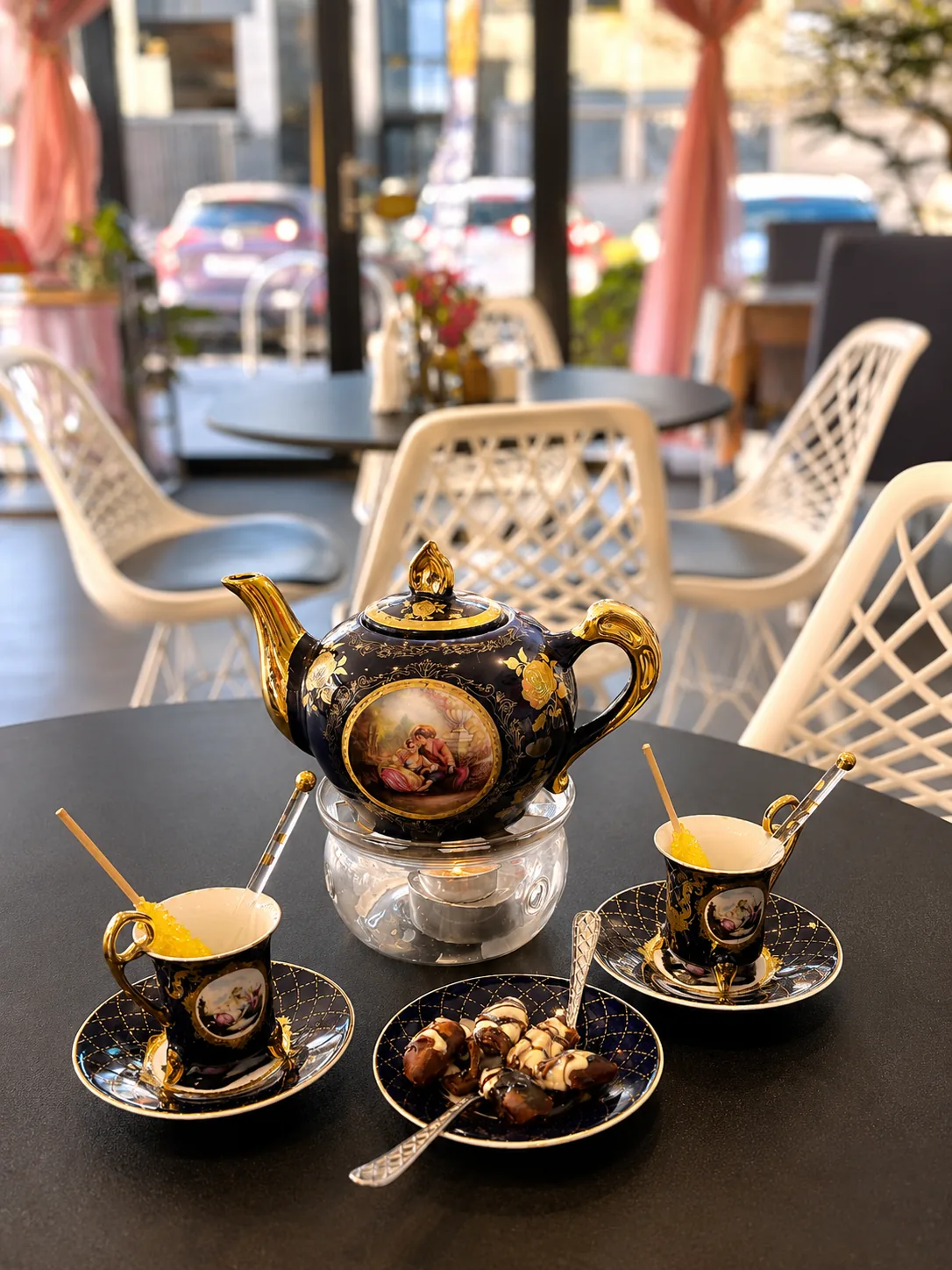 Persian tea service with an ornate navy teapot, tea cups and dates